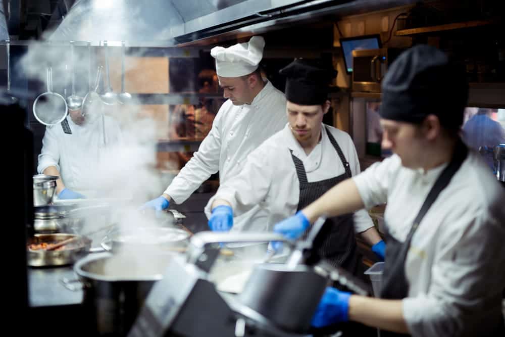 Chefs cooking in a busy kitchen