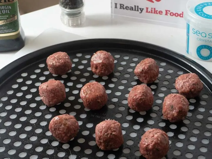 Meatballs on a roasting tray before going into oven