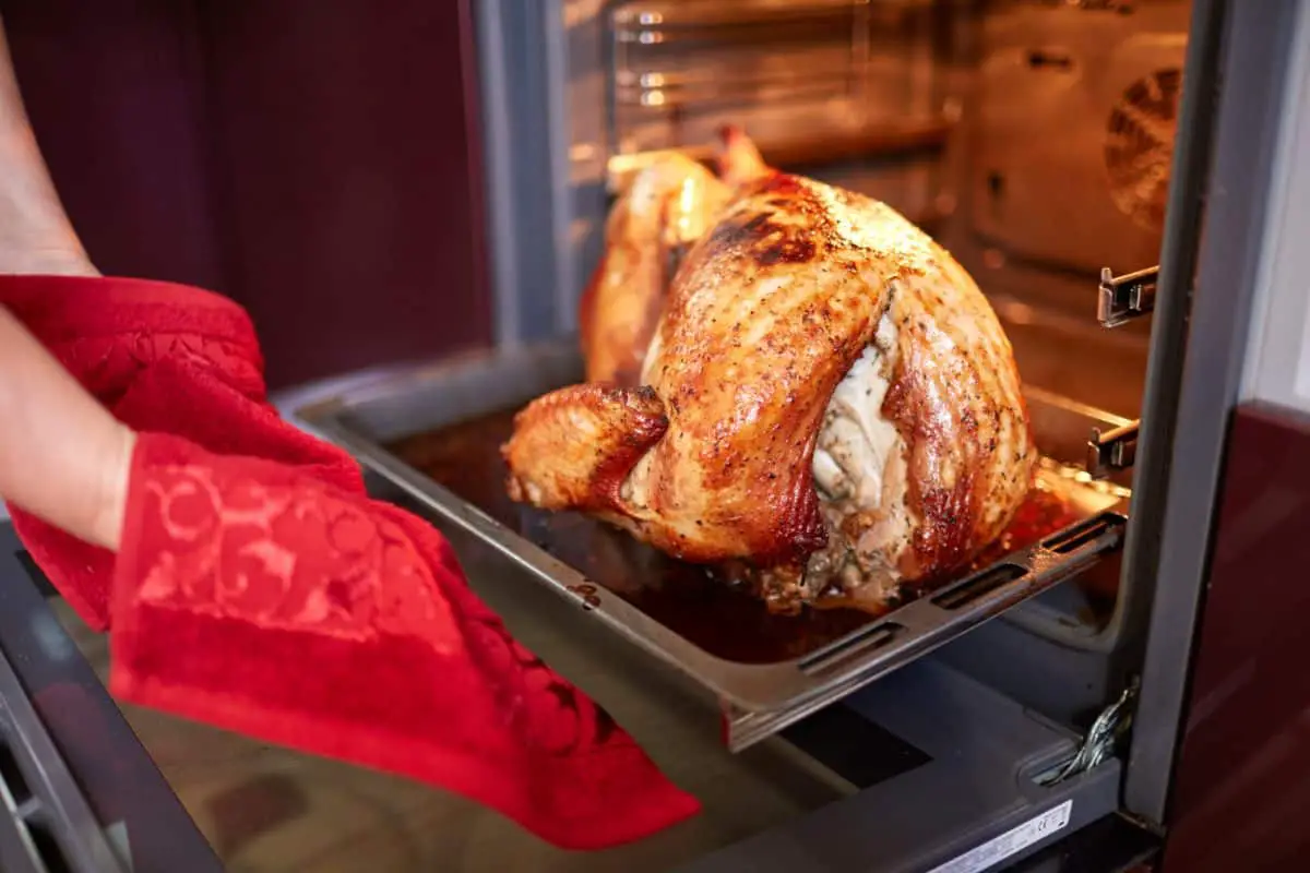 baked turkey coming out in the oven