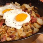 beef hash with egg in a pan